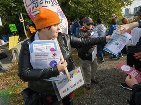 Breanna Himmelright, a member of Autistics United, hands out information leaflets during Autism Speaks Canada's walk in Richmond on Sunday.
