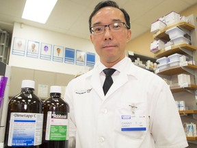 Pharmacist Danny Tam with some of the codeine-containing cough syrups that will require a special type of prescription and will have to be locked up in vaults at pharmacies.