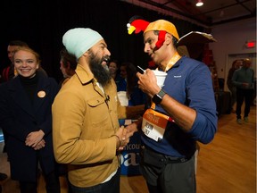 NDP Leader Jagmeet Singh says hello to Kevin Koonar (R) during a campaign stop at the Turkey Trot run on Granville Island on Thanksgiving Day Oct. 14.