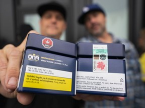 Customers show off their purchases upon leaving the B.C. Cannabis Store in Kamloops on Oct. 17, 2018, the first day that marijuana became legal in Canada.