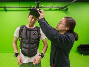 Employees Eric Lui and Karen Zhu inside virtual reality gaming room at Sandbox VR in Richmond, October 27, 2019.