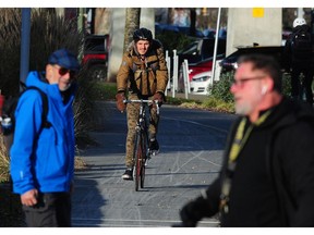 Cyclists enjoy the sunny cold weather in Vancouver, B.C. On Thursday morning the temperature dipped to a record - 0.7 C at YVR.