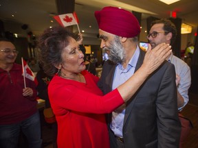 Hedy Fry, re-elected in Vancouver Centre, hugs Harjit Sajjan, re-elected in Vancouver South, at the Liberals' victory party Monday night.
