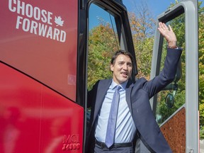 Liberal leader Justin Trudeau waves to supporters as he boards his campaign bus, Tuesday, October 1, 2019 in Richmond Hill, Ont.