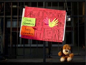 A sign and stuffed animal lay at the entrance to Sir Winston Churchill Secondary School ahead of a vigil for murdered 14-year-old Devan Selvey, at his high school, in Hamilton, Ont., Wednesday, Oct. 9, 2019. Hearing about the stabbing death of a 14-year-old boy outside a school in Hamilton has Darrel Crimeni grappling with questions of bullying and a lack of empathy that may also have played a role when his grandson's overdose was filmed and posted on social media.