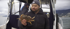 Chang holds up a Dungeness crab.