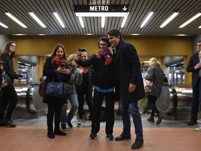 Prime Minister Justin Trudeau greets commuters at a metro station in Montreal, Tuesday, Oct. 22, 2019.