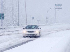 FILE PHOTO :  A car struggles in the snow on the Coquihalla.