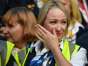 A former Thomas Cook employee wipes her face while protesting in London. Hundreds of Thomas Cook workers protested in Westminster calling for an enquiry into the collapse of firm.