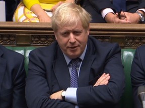 A video grab from footage broadcast by the UK Parliament's Parliamentary Recording Unit (PRU) shows Britain's Prime Minister Boris Johnson reacts as Britain's main opposition Labour Party leader Jeremy Corbyn speaks on a point of order after the House of Commons in London on October 19, 2019 voted to back an amendment in the name of former Conservative MP Oliver Letwin which delays the decision on the Brexit deal.