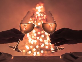 Couple making a Christmas dinner celebration toast. Getty stock photo. For 1214 salut gismondi [PNG Merlin Archive]