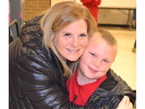 Hugs from child and youth care worker Amy Lauwers during breakfast at Prince Charles Elementary School in Surrey, one of many schools needing help.