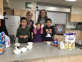 Breakfast at Nanaimo's Brechin Elementary with principal Kim Hart, left, and Jane Bourke, who runs the breakfast program. And some of their happy students.