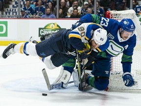 Vancouver Canucks blueliner Alex Edler (right) hauls down St. Louis Blues centre Ryan O'Reilly in what was an intensely physical NHL game at Rogers Arena on Nov. 5, 2019.