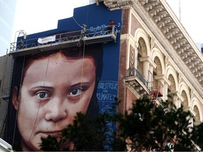 SAN FRANCISCO, CALIFORNIA - NOVEMBER 11: A view of a new four-story-high mural of Swedish climate activist Greta Thunberg on November 11, 2019 in San Francisco, California. A new mural honoring 16 year-old Swedish climate activist Greta Thunberg is nearing completion on the side of a building near San Francisco's Union Square. The mural was designed by Andrés Petreselli and funded by non-profit group OneAtmosphere.org.