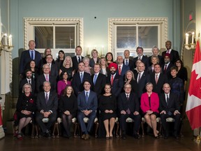 The new Liberal minority cabinet pose for a family photo following their swearing in at Rideau Hall in Ottawa on Wednesday, Nov. 20, 2019.