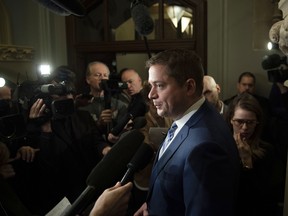 Conservative leader Andrew Scheer speaks to reporters in a hallway after leaving a meeting with Prime Minister Justin Trudeau in his office in Ottawa on Tuesday, Nov. 12, 2019.