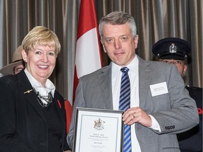 Jim Fisher, pictured receiving a community crime prevention award from former attorney general Suzanne Anton in 2014, was a decorated officer before being convicted of sex-related offences against vulnerable victims.
