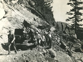 Workers carve out the Hope-Princeton Highway through a rocky cliff, late 1940s. Sun files.