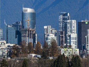A construction crane is seen along the Vancouver skyline in November 2019. There is low vacancy for commercial property in the city, but millions of square feet of new stock are on the way.