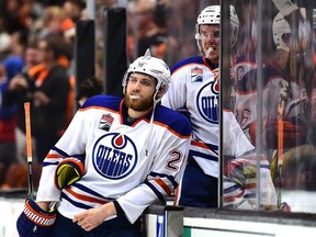 Oilers' stars Leon Draisaitl, left and Connor McDavid look to lower the boom on the visiting Vancouver Canucks Saturday night at Rogers Place in Edmonton.