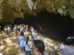 This handout photo taken on November 1, 2019 and released by Department of National Parks, Wildlife and Plant Conservation shows people visiting Tham Luang cave in the Mae Sai district of Thailand's northern Chiang Rai province. - Thailand reopened the cave on November 1 where 12 young footballers and their coach were trapped last year in a saga that captivated the world.