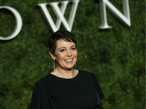 British actress Olivia Colman poses for a photo with a fan on the red carpet upon arrival for the World premiere of the television series "The Crown - Series 3" in London on November 13, 2019.