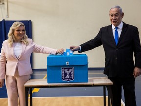 Israeli Prime Minister Benjamin Netanyahu and his wife Sara casts their votes during Israel's parliamentary election at a polling station in Jerusalem September 17, 2019.