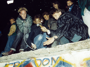 West Berliners break the Berlin Wall with hammers and crosses on Nov. 10, 1989.