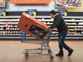 A man shops for a television in Walmart on Thanksgiving night ahead of Black Friday on November 28, 2019 in King of Prussia, United States.