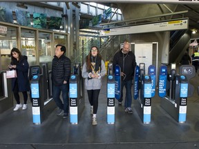 Transit customers exit the Lougheed Town Centre SkyTrain Station in Burnaby on Thursday.