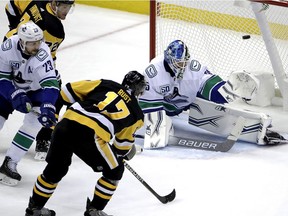 Bryan Rust gets a shot past Canucks goaltender Thatcher Demko for a goal during the first period.