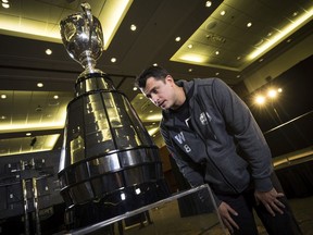 Winnipeg Blue Bombers quarterback Zach Collaros checks out the Grey Cup during media day in Calgary. Collaros hopes to get his name on the Cup by beating the Hamilton Tiger-Cats on Sunday afternoon.
