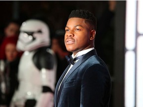 Actor John Boyega poses for photographers as he arrives for the European Premiere of 'Star Wars: The Last Jedi', at the Royal Albert Hall in central London, Britain, December 12, 2017.