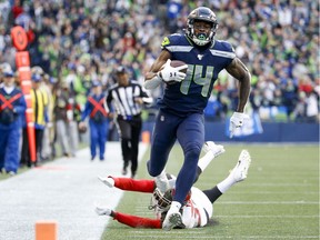 Nov 3, 2019; Seattle, WA, USA; Seattle Seahawks wide receiver D.K. Metcalf (14) runs for yards after the catch for a touchdown against the Tampa Bay Buccaneers during the fourth quarter at CenturyLink Field. Mandatory Credit: Joe Nicholson-USA TODAY Sports