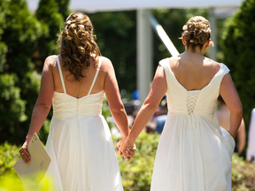 A couple arrives to take part in a mass gay wedding in Toronto in 2014.