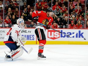 Chicago Blackhawks centre Jonathan Toews deflects the puck in front of Washington Capitals' goaltender Braden Holtby during NHL action earlier this season.