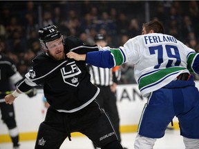 Kyle Clifford fights against Micheal Ferland during the first period at Staples Center.