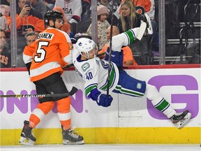 Philadelphia Flyers defenceman Matt Niskanen checks Vancouver Canucks centre Elias Pettersson during the second period.