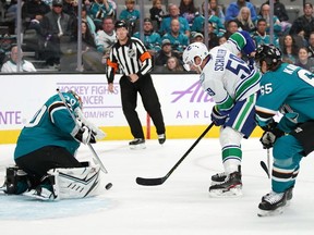 Nov 2, 2019; San Jose, CA, USA; Vancouver Canucks center Tim Schaller (59) attempts a shot as San Jose Sharks goaltender Aaron Dell (30) makes a save during the first period at SAP Center at San Jose. Mandatory Credit: Darren Yamashita-USA TODAY Sports