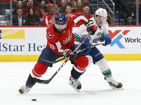 Washington Capitals defenseman Radko Gudas (33) skates with the puck as Vancouver Canucks right wing Brock Boeser (6) defends in the second period at Capital One Arena.