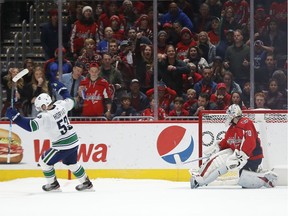 Captain Bo Horvat of the visiting Vancouver Canucks celebrates after scoring the game-winning goal in the seventh round of a shootout on Saturday against Washington Capitals' goaltender Braden Holtby.