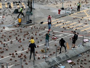 Small piles of bricks are piled in the streets outside the Polytechnic University in Hong Kong to stop traffic and prevent ease access by police.