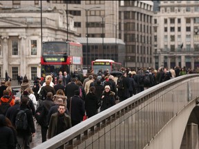 City workers cross London Bridge as they commute to work on Nov. 20, 2012 in London. (Oli Scarff/Getty Images)