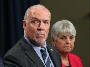 Finance Minister Carole James (right) and Premier John Horgan are struggling to a balanced budget as economic growth cools.