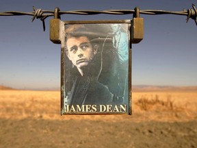 FILE PHOTO: A portrait of U.S. actor James Dean hangs from a fence near the intersection of Highways 46 and 41 near Cholame, California September 30, 2005./