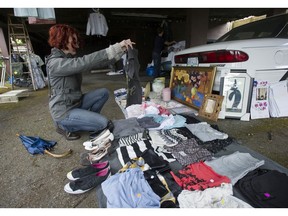 Damp weather didn't deter buyers and sellers at yard and garage sales near Commercial Drive in Vancouver on June 18, 2016.