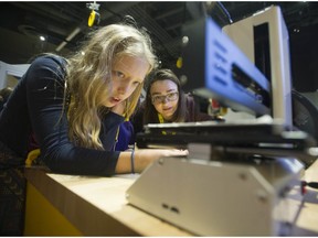 Scarlett Enzinas, 11, (left) takes part in the Girls and STEAM event at Science World on Saturday.