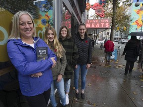 Kristi Blakeway, left, with student volunteer helpers Mya Jakovljevich, Sophia Scarcely and Piper Richardson on East Hastings Street in Vancouver Nov. 9, 2019. Blakeway, a school principal, started a program 10 years ago when she was a teacher to introduce her students to the needs of the homeless in the Downtown Eastside. That outreach has now helped about 700 people from the DTES to reconnect with their families. Now, Blakeway has written a book that will be launched in the DTES on Nov. 12: Beyond Hello: Rekindling the Human Spirit One Conversation at a Time.
