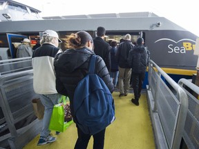 Transit riders board a SeaBus to North Vancouver from Waterfront station.